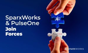 Two hands about to connect puzzle pieces with the SparxWorks and PulseOne logos. Text: 'SparxWorks & PulseOne Join Forces'.